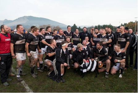 Image of Waihora team and Mascot cheering while posing for a group photo